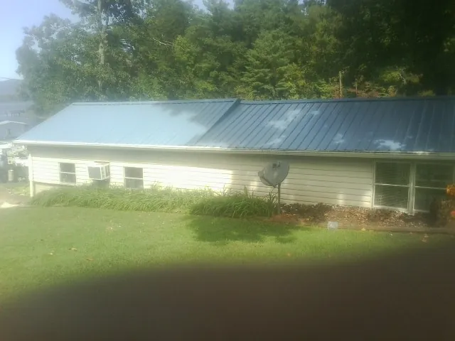 Blue metal roof running the length of a single story home in Herington